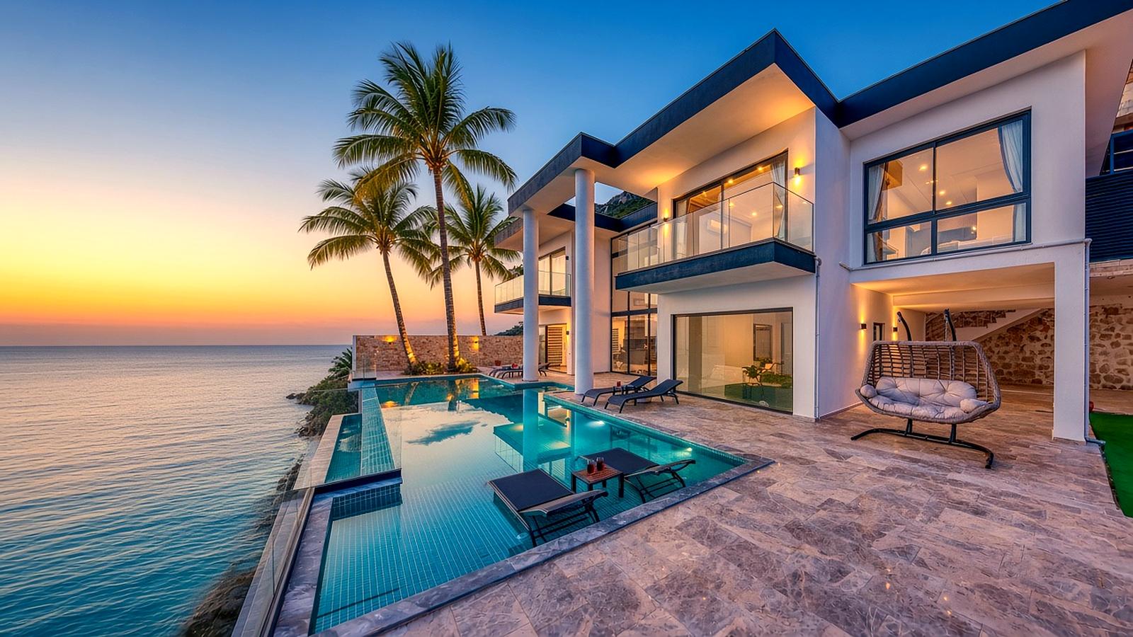 A modern villa with an infinity pool and palm trees at sunset (illustrative image)